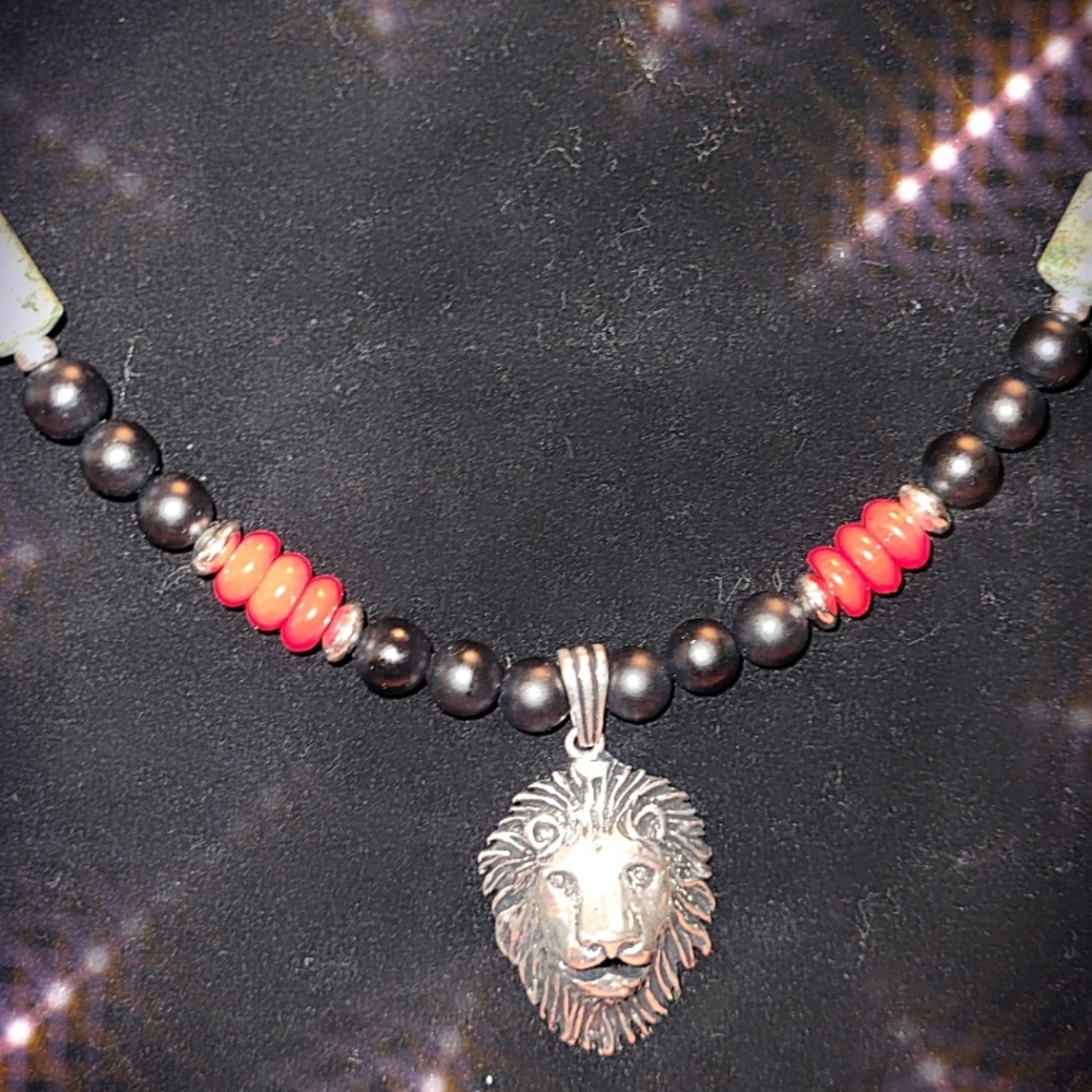 Sterling silver pendant with onxy and red coral beading.